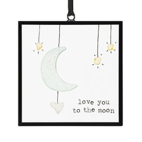 A small square suncatcher with a moon and stars made out of small colored stones and the saying "love you to the moon".