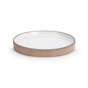 A small white circular tray with a tan texture around the outside, displayed at an angle to show depth.