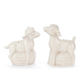 A set of two cream ceramic salt and pepper shakers shaped like little lambs.