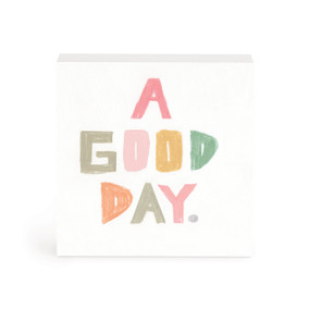 A small white box artwork of the saying "A good day" in colored pastel colors.