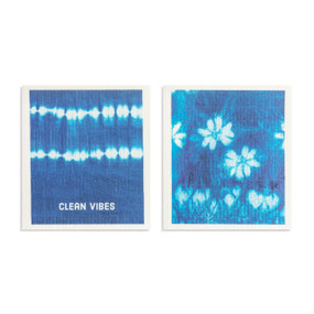 Two blue and white biodegradable dish cloths. One is a blue and white floral pattern and the other has a blue and white tie dye look and the saying "Clean Vibes".