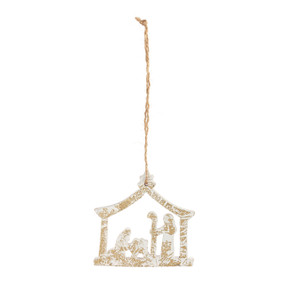 A wood stable shaped ornament with the nativity scene and partially painted in white.