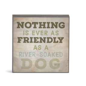 A small square brown wall art with the saying "Nothing is ever as friendly as a river-soaked dog".