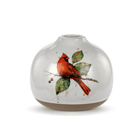 A small round white ceramic vase with a tan textured base and a watercolor cardinal on a branch.