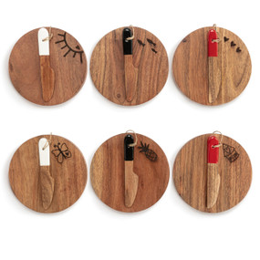 A set of six round mini wood serving boards with small wood spreaders. Each board has a different graphic.