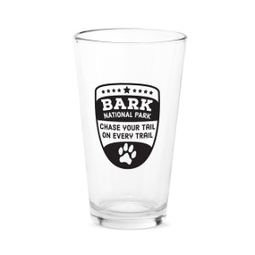 A clear pint glass with the saying "Bark national park. Chase your tail on every trail"