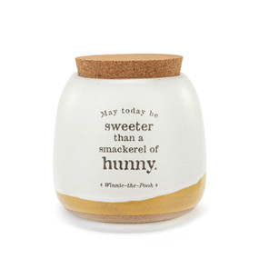 A white ceramic round canister with a tan textured base and cork lid. The container says "May today be sweeter than a smackerel of hunny."