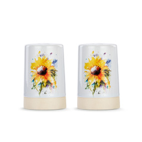 A set of two white ceramic salt and pepper shakers with a cream textured base. There is a watercolor image of sunflowers on them.