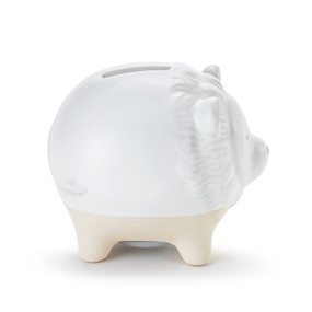 A white ceramic piggy bank with the face and tail of a lion. The feet of the bank are cream and textured.
