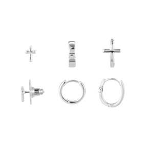 A set of three dainty silver hoop and stud cross earrings.