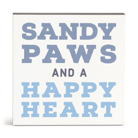 A square white wall art with the saying "Sandy paws and a happy heart".