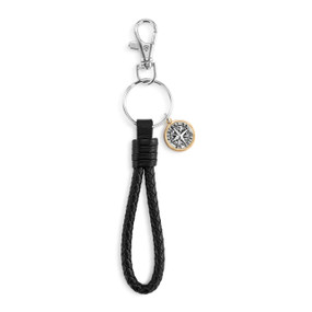 A black leather braided keychain with a silver metal lobster clasp. The keychain has a round silver compass medallion with a gold rim.
