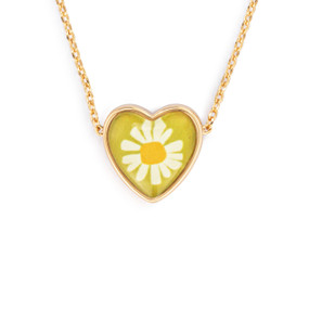 Detail view of the charm on an adjustable gold chain necklace with a heart shaped charm of a daisy on a yellow background.