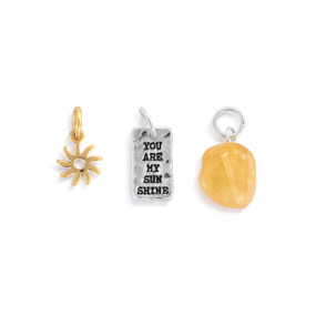 A set of three different gold and silver charms about sunshine.