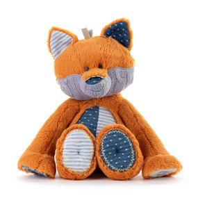 An orange plush fox with a knit purple jaw. The fox has dark and light blue ears, tummy and paws.