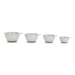 A set of four white ceramic measuring cups with tan textured bases.