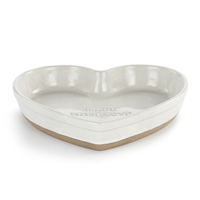A white heart shaped ceramic dish with a tan textured base. The inside says "Made with Love".