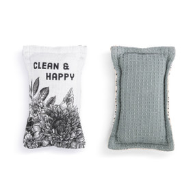 A set of two fabric kitchen sponges. On has black and white floral artwork and the saying "Clean & Happy" and the other is gray.