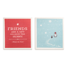 Two biodegradable dish cloths. One is blue with Pooh and Piglet walking in the snow and the other is red and says "Friends are a gift even sweeter than hunny".