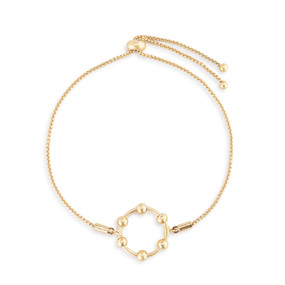 An adjustable gold chain bracelet with a round gold charm with six gold beads on it that move.