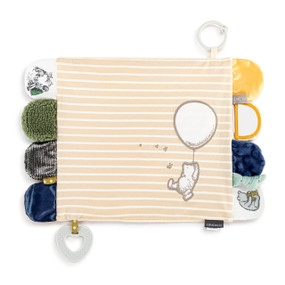 A tan and white striped fabric blankie with Pooh hanging from a balloon and tabs on each end in different fabrics and textures. The blankie also has a teether and stroller ring attached.