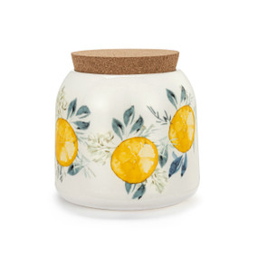 A small sized white ceramic container with a cork lid. The container has illustrated lemons and leaves.