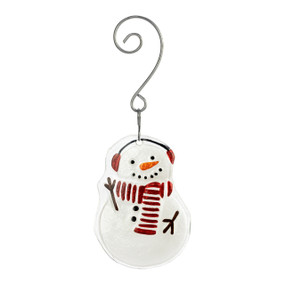 A glass ornament of a snowman wearing a red and white striped scarf and earmuffs with a curved silver hanger.