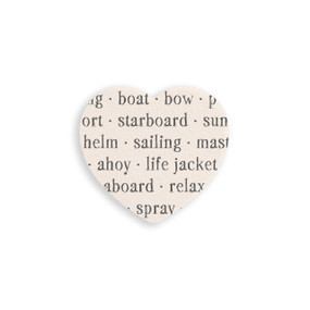 A set of four heart shaped white ceramic coasters with words about sailing on it.