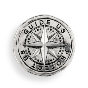 A round silver metal visor clip with a compass symbol and it says "Guide Us Protect Us".