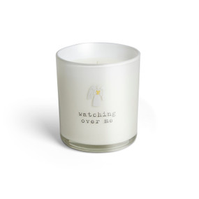 A white glass candle that says "watching over me" and has a small white angel holding a yellow heart on the front.