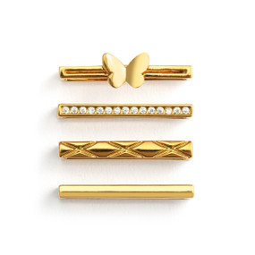 Four different gold charms that fit on a smart watch band. One has a butterfly charm.