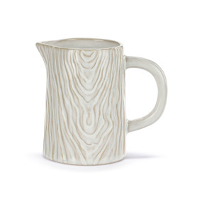 A small white pitcher with a handle and a wood grain appearance.