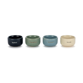 A set of four small ceramic pinch bowls in different blue colors. Each has a different word on the front including joyful, thankful, blessed and loved.
