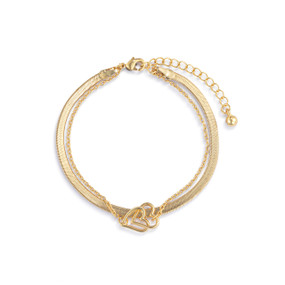An adjustable layered gold bracelet with a gold charm of interlocking hearts.