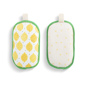 A set of two absorbent sponges with a white and yellow lemon pattern. Each has a fabric tab at the top for hanging.