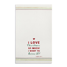 A white kitchen towel with the saying "I Love Christmas so much I want to kiss it" displayed laid out flat.