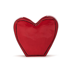 A heart shaped red ceramic vase.