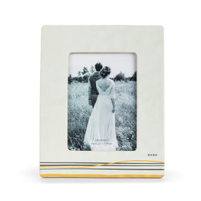 A 5x7 cream ceramic frame with gold and black lines at the bottom and the saying "xoxo" at the bottom right.
