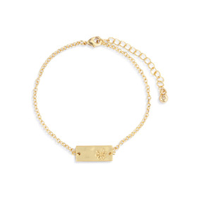 An adjustable gold chain bracelet with a rectangular gold charm with a flower on it.