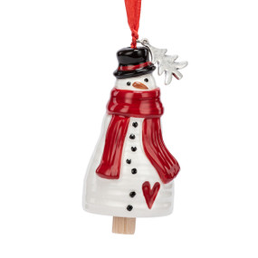 A small white bell shaped like a snowman wearing a red scarf and has a silver metal tree charm at the top.