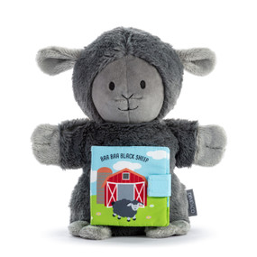 A dark gray plush sheep puppet with a fabric book attached to its front with the title "Baa Baa Black Sheep".