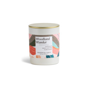 A 3.5 oz woodland wonder scented candle in a round white container with a gold lid.