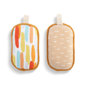 A set of two absorbent sponges with yellow, orange and blue thick lines. Each has a fabric tab at the top for hanging.