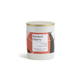 A 3.5 oz smoked cherry scented candle in a round white container with a gold lid.