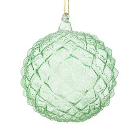 A light green round ornament with little triangle shapes around it.