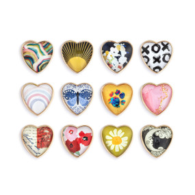 A set of 12 different heart shaped enamel pins with various images.