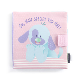 A light pink fabric activity baby book with an illustrated puppy on the front and the title "Oh, How Special You Are!".