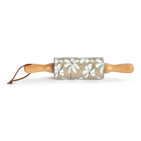 A small brown decorative ceramic rolling pin with wood handles and white illustrated flowers on the roller.