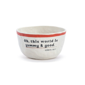 A white crinkly melamine bowl with a red rim and the saying "Oh, this world is yummy & good".