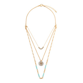 An adjustable gold chain necklace with three layers including turquoise and gold beads and a round silver charm with a gold cross.